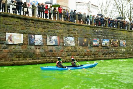 VILNIUS, LITHUANIA - MARCH 16, 2019: Hundreds of people enjoying festivities and celebrating St. Patrick`s day in Vilnius. Vilnele river was dyed green to mark the patron saint of Ireland`s day.のeditorial素材