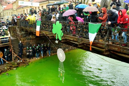 VILNIUS, LITHUANIA - MARCH 16, 2019: Hundreds of people enjoying festivities and celebrating St. Patrick`s day in Vilnius. Vilnele river was dyed green to mark the patron saint of Ireland`s day.のeditorial素材