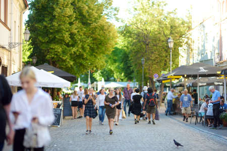 VILNIUS, LITHUANIA - JUNE 18, 2019: Townspeople and tourists strolling on the Pilies Street, the oldest and most flamboyant street in the Old Town of Vilnius.のeditorial素材