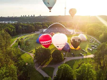 VILNIUS, LITHUANIA - JULY 3, 2020: Colorful hot air balloons taking off in Vingis park in Vilnius city on sunny summer evening. Lots of people watching as balloons fly away.のeditorial素材