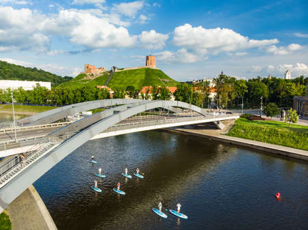 Stand up paddle boarders passing by Gediminas Tower, the remaining part of the Upper Castle in...