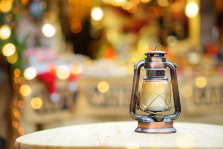 Lantern as a decoration of a wooden table on Christmas market in Riga, Latvia.の写真素材