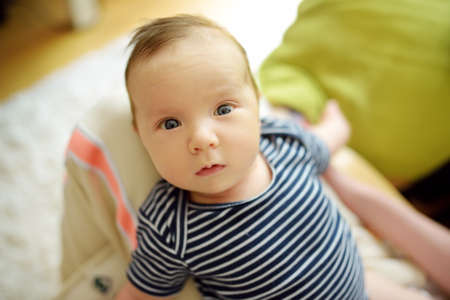Cute three months old baby boy playing with his mommy. Baby during playtime.