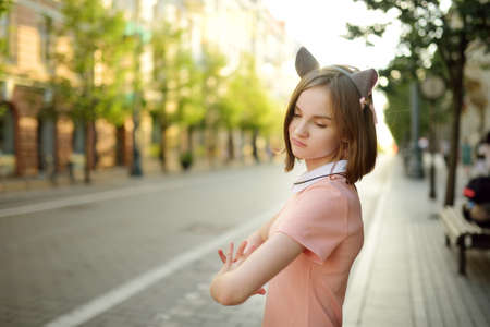 Cute young girl sightseeing on the streets of Vilnius, Lithuania on warm and sunny summer day. Family leisure with kids.の写真素材