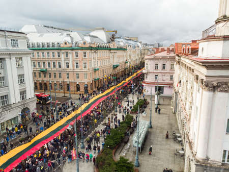 VILNIUS, LITHUANIA - MARCH 11, 2020: Aerial view of festive parade as Lithuania marked the 30th anniversary of its independence restoration. Parade participants carrying national flags.のeditorial素材