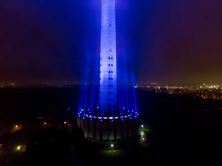 VILNIUS, LITHUANIA - FEBRUARY 11, 2020: Aerial night foggy view of Vilnius TV tower illuminated in blue for 30th Anniversary of the first commercial radio station M1.のeditorial素材