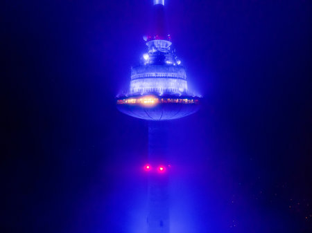 VILNIUS, LITHUANIA - FEBRUARY 11, 2020: Aerial night foggy view of Vilnius TV tower illuminated in blue for 30th Anniversary of the first commercial radio station M1.のeditorial素材