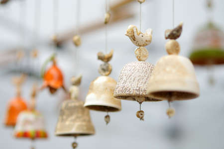Colorful ceramic bells and other decorations sold on Easter market in Vilnius. Lithuanian capital's annual traditional crafts fair is held every March on Old Town streets.の写真素材