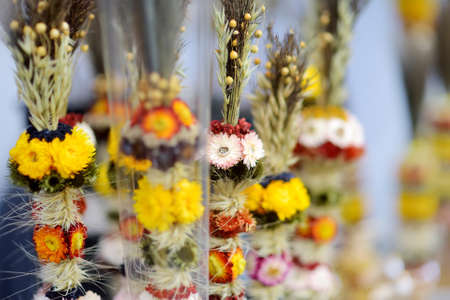 Traditional Lithuanian Easter palms known as verbos sold on Kaziukas, Easter market in Vilnius. Lithuanian capital's annual traditional crafts fair is held every March on Old Town streets.の写真素材
