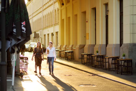 VILNIUS, LITHUANIA - AUGUST 20, 2020: Townspeople and tourists strolling on the Didzioji Street, the oldest and most flamboyant street in the Old Town of Vilnius.のeditorial素材