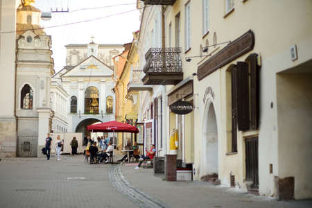 VILNIUS, LITHUANIA - AUGUST 20, 2020: Townspeople and tourists strolling on the Didzioji Street, the oldest and most flamboyant street in the Old Town of Vilnius.のeditorial素材