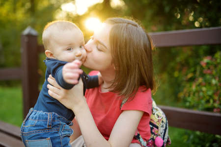 Cute big sister admiring her baby brother. Adorable teenage girl holding her new baby boy brother. Kids with large age gap. Big age difference between siblings. Big family.の写真素材