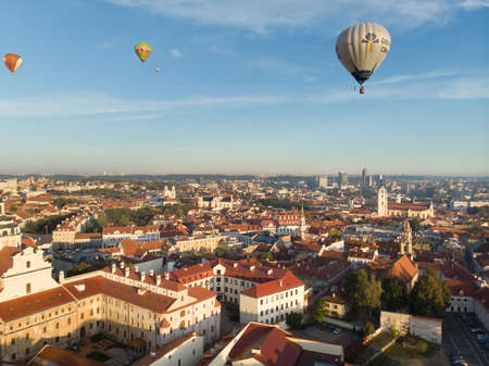 VILNIUS, LITHUANIA - AUGUST 20, 2020: Colorful hot air balloons taking off in Old town of Vilnius city on sunny summer morning. Lots of people watching as balloons fly away.のeditorial素材