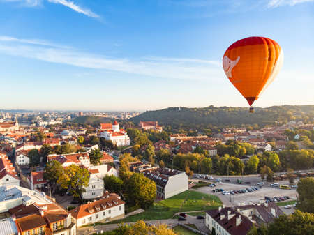VILNIUS, LITHUANIA - AUGUST 20, 2020: Colorful hot air balloons taking off in Old town of Vilnius city on sunny summer morning. Lots of people watching as balloons fly away.のeditorial素材