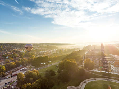 VILNIUS, LITHUANIA - AUGUST 20, 2020: Colorful hot air balloons taking off in Old town of Vilnius city on sunny summer morning. Lots of people watching as balloons fly away.のeditorial素材