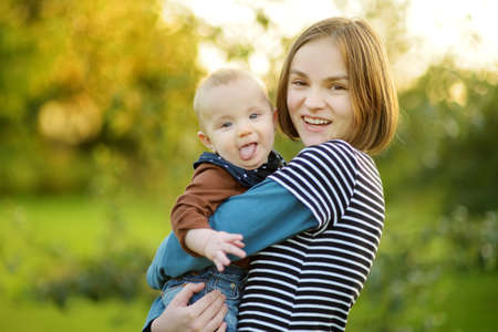 Cute big sister admiring her baby brother. Adorable teenage girl holding her new baby boy brother....