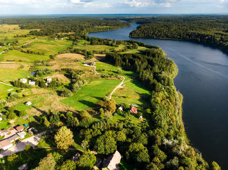 Aerial landscape view of Lake Asveja, the longest lake in Lithuania. Cognitive trails through Dubingiai Hill, archaeological and natural sites.の写真素材