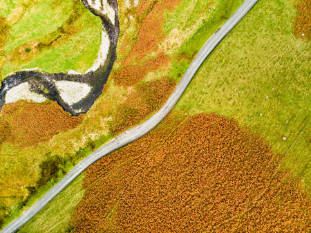 Aerial view of Honister Pass, a mountain pass with a road winding along Gatesgarthdale Beck mountain...