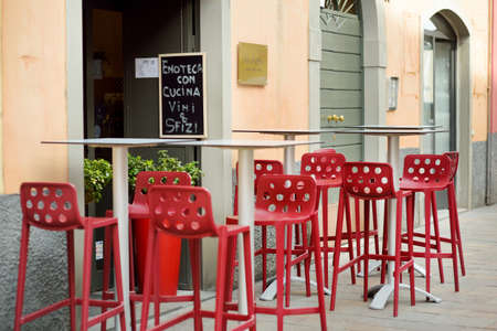 BERGAMO, ITALY - APRIL 2019: Empty small outdoor restaurant tables and chairs in the city of Bergamo, Italyのeditorial素材