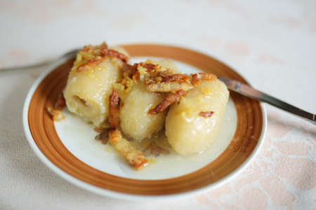 Cepelinai, dumplings made of grated and riced potatoes and stuffed with ground meat, dry curd cheese or mushrooms. National dish of Lithuania, typically served as a main dishの写真素材