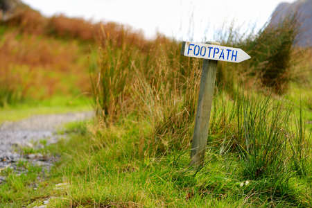 White FOOTPATH sign in the Lake District, famous for its glacial ribbon lakes and rugged mountains. Popular vacation destination in Cumbria, North West England.の写真素材