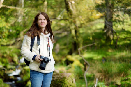 Tourist exploring the woodland near Buttermere lake, located in the Lake District, UK, offering...