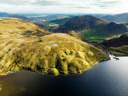 Aerial view of Stickle Tarn lake, located in the Lake District, Cumbria, UK. Popular tourist attractions in Great Langdale valley, famous for its glacial ribbon lakes and rugged mountains.の写真素材