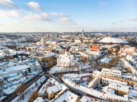 Beautiful Vilnius city panorama in winter with snow covered houses, churches and streets. Aerial evening view. Winter city scenery in Vilnius, Lithuania.の写真素材