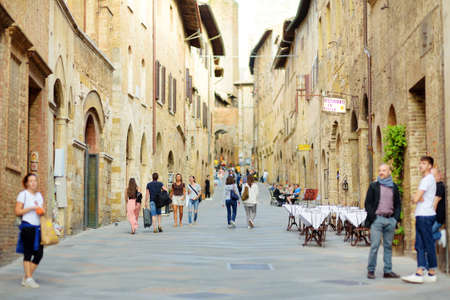 SAN GIMIGNANO, ITALY - JUNE 3, 2019: Famous medieval San Gimignano hill town with its skyline of medieval towers, including the stone Torre Grossa. Province of Siena, Tuscany, Italy.のeditorial素材