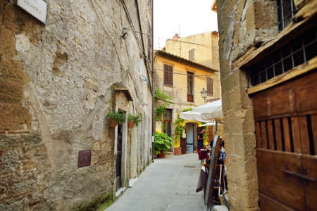 PITIGLIANO, ITALY - JUNE 8, 2019: Narrow old streets of the famous Pitigliano town, located atop a...