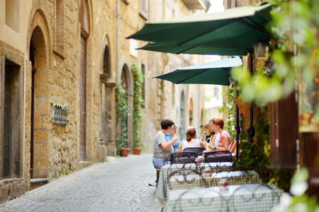 ORVIETO, ITALY - JUNE 11, 2019: Streets of the famous Orvieto, a medieval hill town, rising above the almost-vertical faces of tuff cliffs and surrounded by its vineyards and wineries in Italy.のeditorial素材