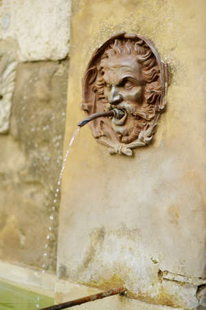 Old drinking water fountain of the famous Pitigliano town, located atop a volcanic tufa ridge. Beautiful italian towns and villages. Etruscan heritage, Grosseto, Tuscany, Italy.の写真素材