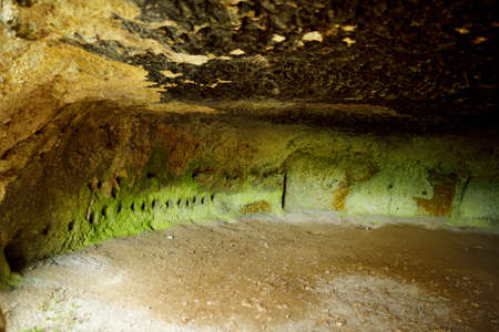 Old caves dug into the tuff rock and used for human habitation in ancient times. Citta del Tufo archaeological park. Sorano, Sovana, Tuscany, Italy.の写真素材
