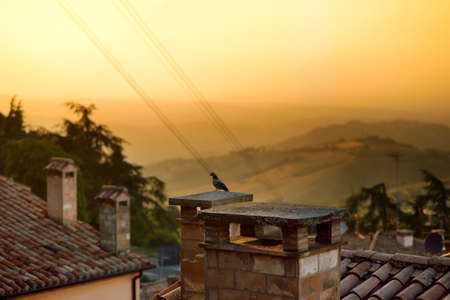 Beautiful sunset view of San Marino microstate and Emilia-Romagna region of Italy from the rooftops of the city of San Marino.の写真素材