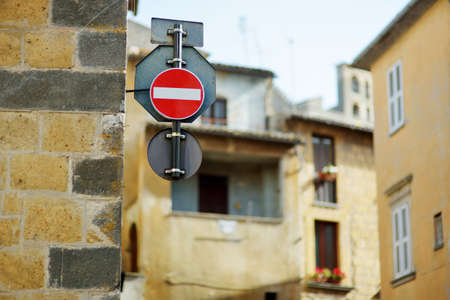 Road sign on the street of Orvieto, a medieval hill town, rising above the almost-vertical faces of tuff cliffs and surrounded by its vineyards and wineries in Umbria, Italy.の写真素材