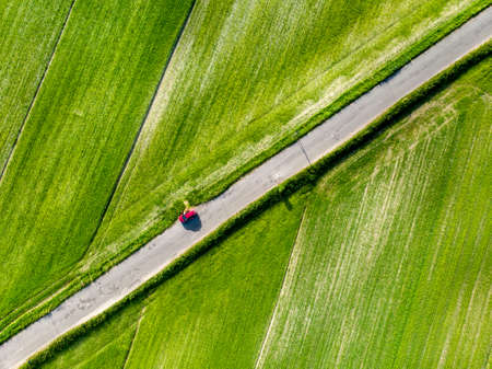 Aerial top down view of Piano Grande, large karstic plateau of Monti Sibillini mountains. Beautiful green fields of the Monti Sibillini National Park, Umbria, Italy.の写真素材