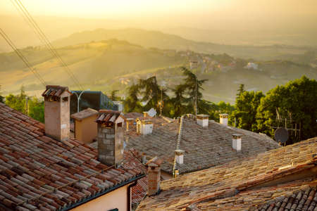 Beautiful sunset view of San Marino microstate and Emilia-Romagna region of Italy from the rooftops of the city of San Marino.の写真素材