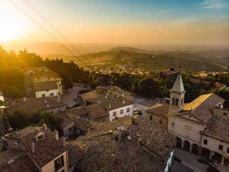 Beautiful aerial sunset view of San Marino microstate and Emilia-Romagna region of Italy from the rooftops of the city of San Marino.の写真素材