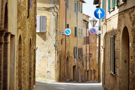 Charming medieval street of Montalcino town, located on top of a hill top and surrounded by vineyards, known worldwide for the production of delicious wine. Tuscany, Italy.の写真素材