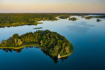 Aerial view of scenic Rubikiai lake, located near Anyksciai town, Lithuania. Beautiful landscape view from the above on summer sunset.の写真素材