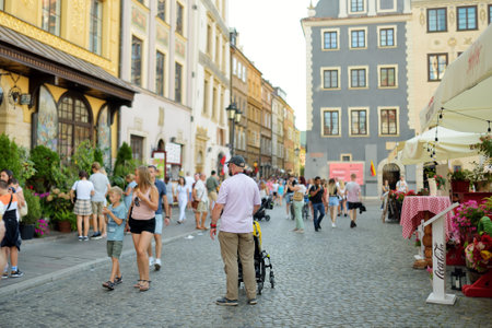 WARSAW, POLAND - AUGUST 2021: Tourists explore beautiful streets of the Old Town which was completely destroyed during the World War II and rebuilt in the years 1949-1953. Sunny summer day.のeditorial素材