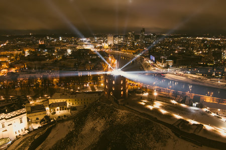 Scenic aerial view of Gediminas tower in Vilnius Old Town beautifully illuminated for 699th birthday celebration. Main symbol of Lithuanian capital at winter night.のeditorial素材