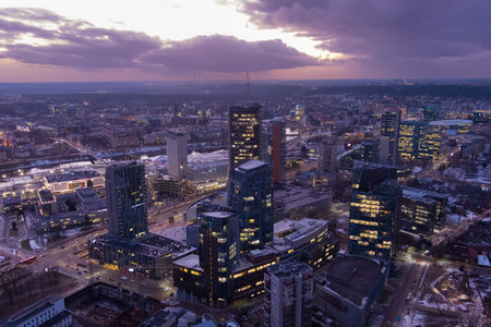 Beautiful aerial evening view of illuminated business district in Vilnius. Scenic winter sunset in capital of Lithuania.のeditorial素材