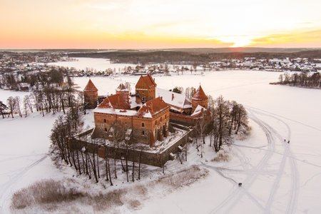 Beautiful aerial view of Trakai Island Castle, located in Trakai, Lithuania. Snow covered frozen Galve lake on sunny winter sunrise. Scenic winter scenery near Vilnius, Lithuania.のeditorial素材