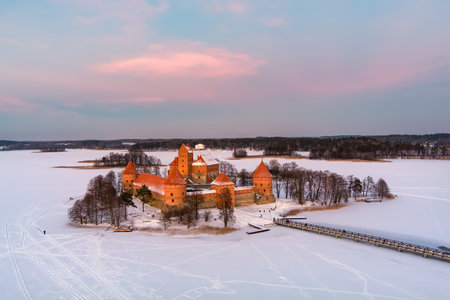 Beautiful aerial view of Trakai Island Castle, located in Trakai, Lithuania. Snow covered frozen Galve lake on sunny winter sunrise. Scenic winter scenery near Vilnius, Lithuania.のeditorial素材