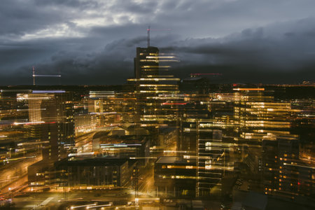 Blurred aerial evening view of illuminated business district in Vilnius. Scenic winter sunset in capital of Lithuania.のeditorial素材