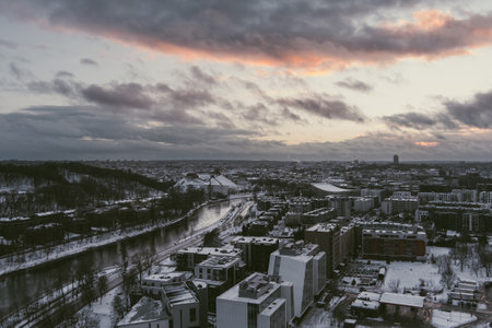 Beautiful Vilnius city panorama in winter with snow covered houses, churches and streets. Aerial sunset view. Winter city scenery in Vilnius, Lithuania.のeditorial素材