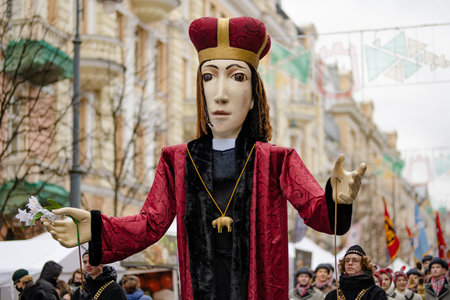 VILNIUS, LITHUANIA - MARCH 4, 2022: Cheerful people participating in humorous parade during Kaziuko muge or Kaziukas, traditional Easter market, crafts fair held every March on Old Town streets.のeditorial素材