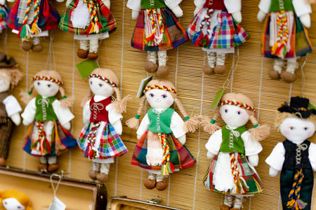 Cute handmade ragdoll dolls in Lithuanian national costumes sold on Easter market in Vilnius. Lithuanian capitals annual traditional crafts fair is held every March on Old Town streets.の写真素材