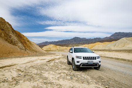 DEATH VALLEY, CALIFORNIA, USA - APRIL 2016: Jeep Grand Cherokee on famous Twenty Mule Teams road in Death Valley National Park, California, USA. Exploring the American Southwest.のeditorial素材